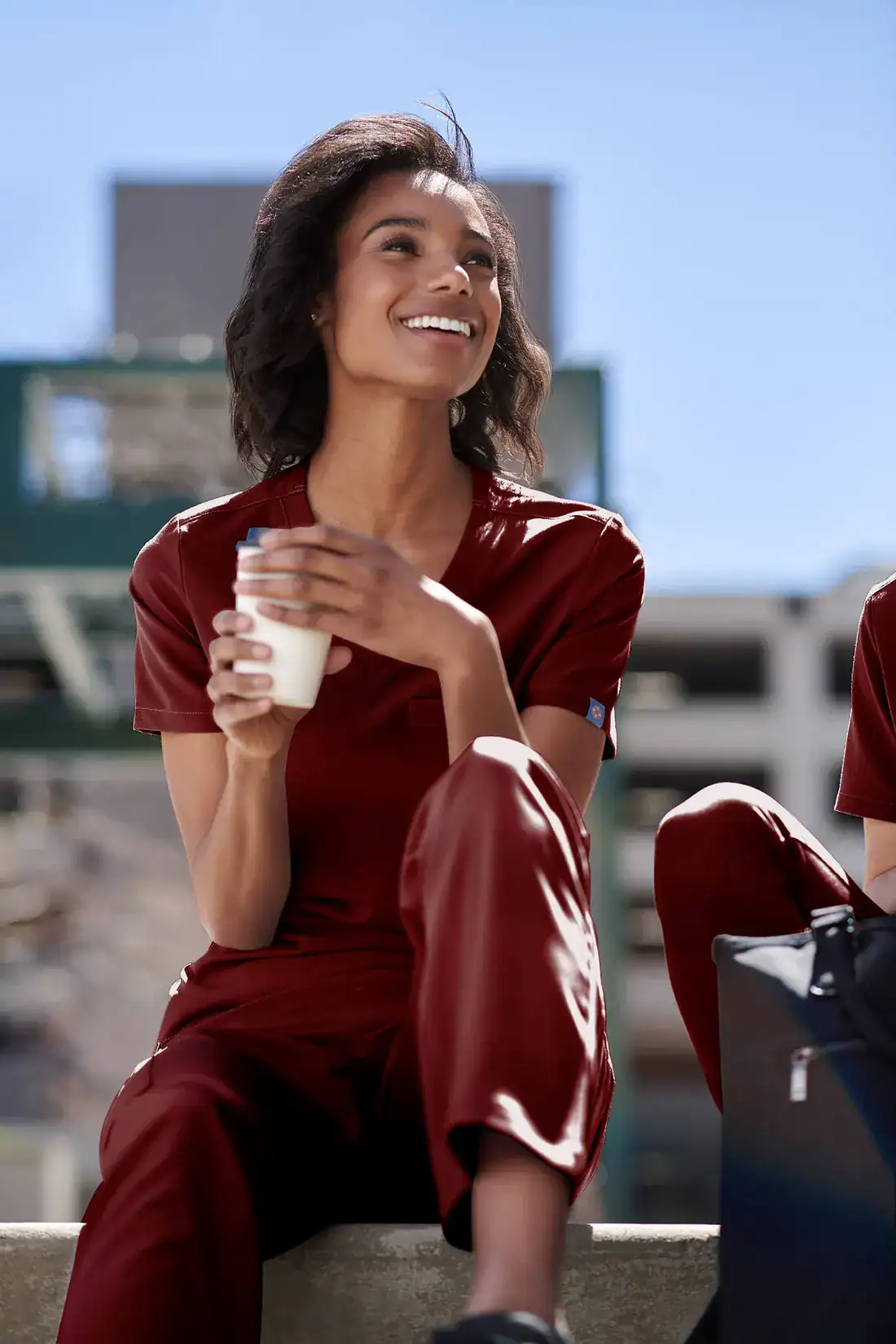 Woman in a Merlot Red MedTailor scrub set